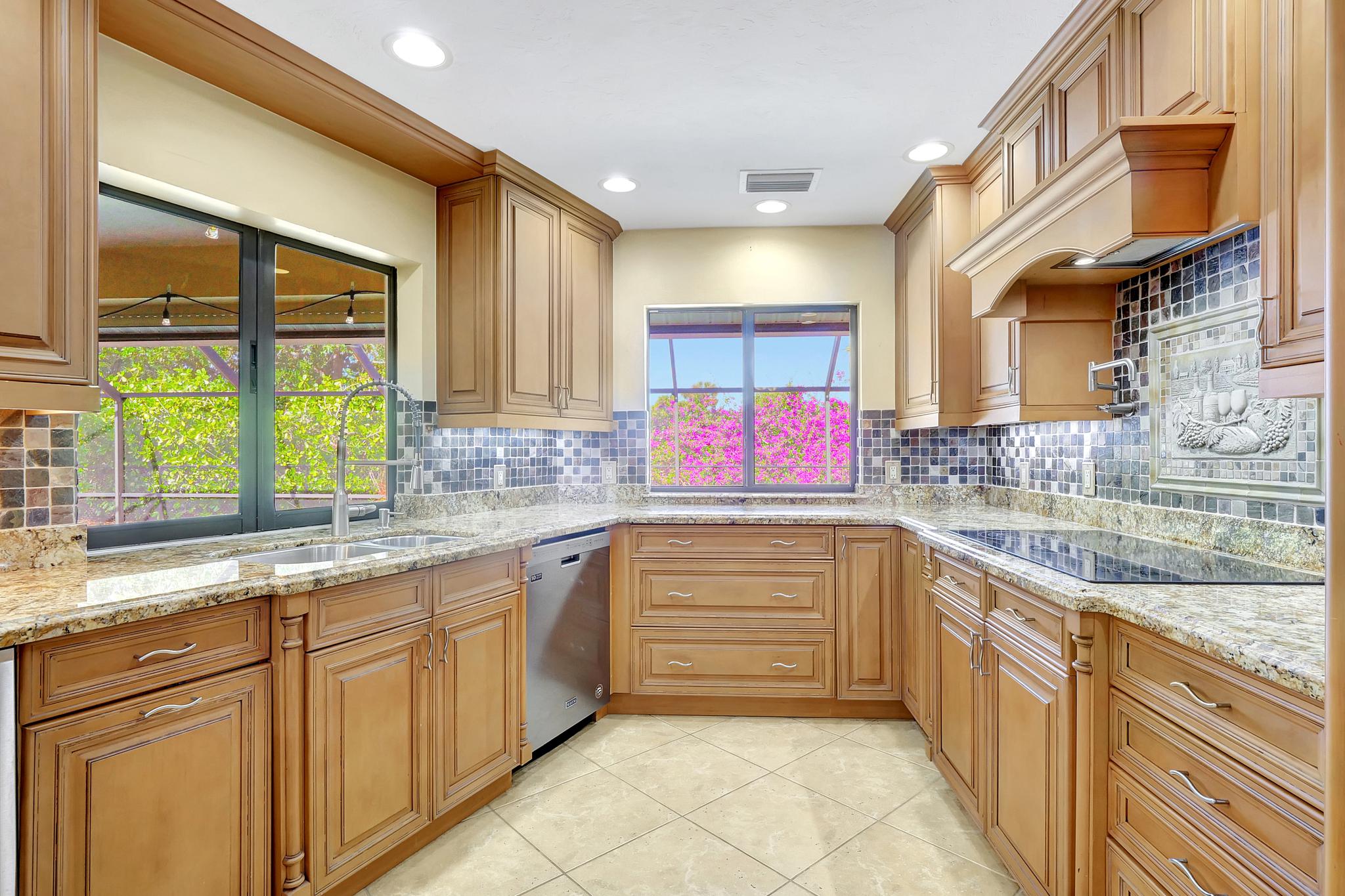 There Is a Pass Thru Window in the Kitchen To the Covered Lanai and the Granite Countertop Continues to the Lanai